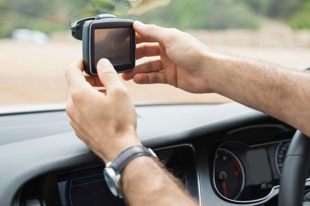 Preparing a sat nav on a car windscreen 