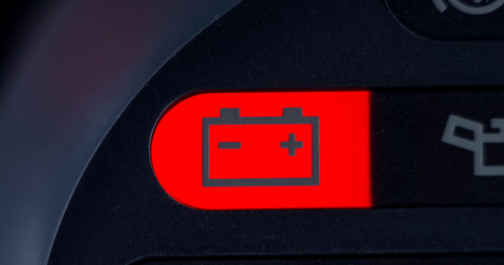 An image showing a battery icon on a dashboard with a red background